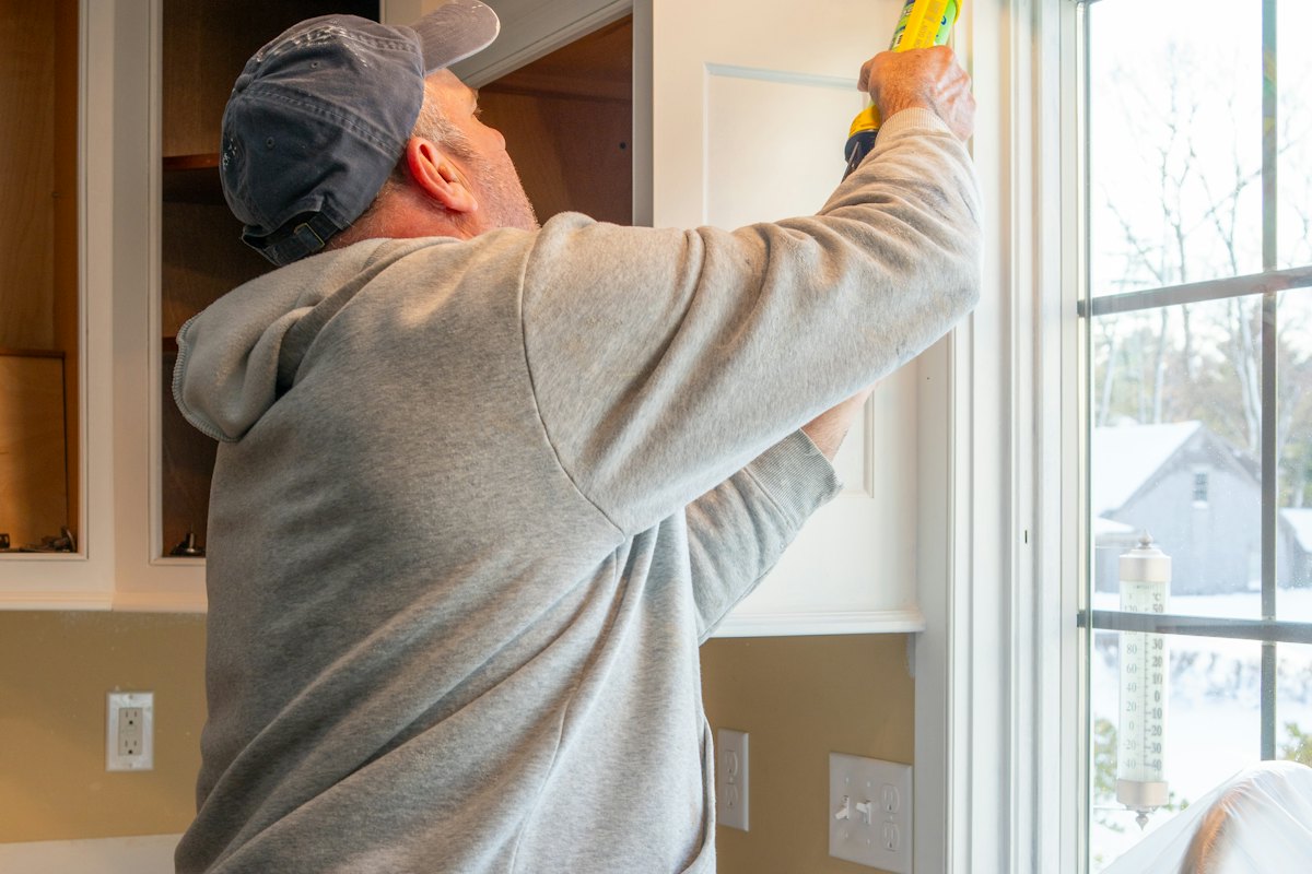 Caulking being applied around a window frame