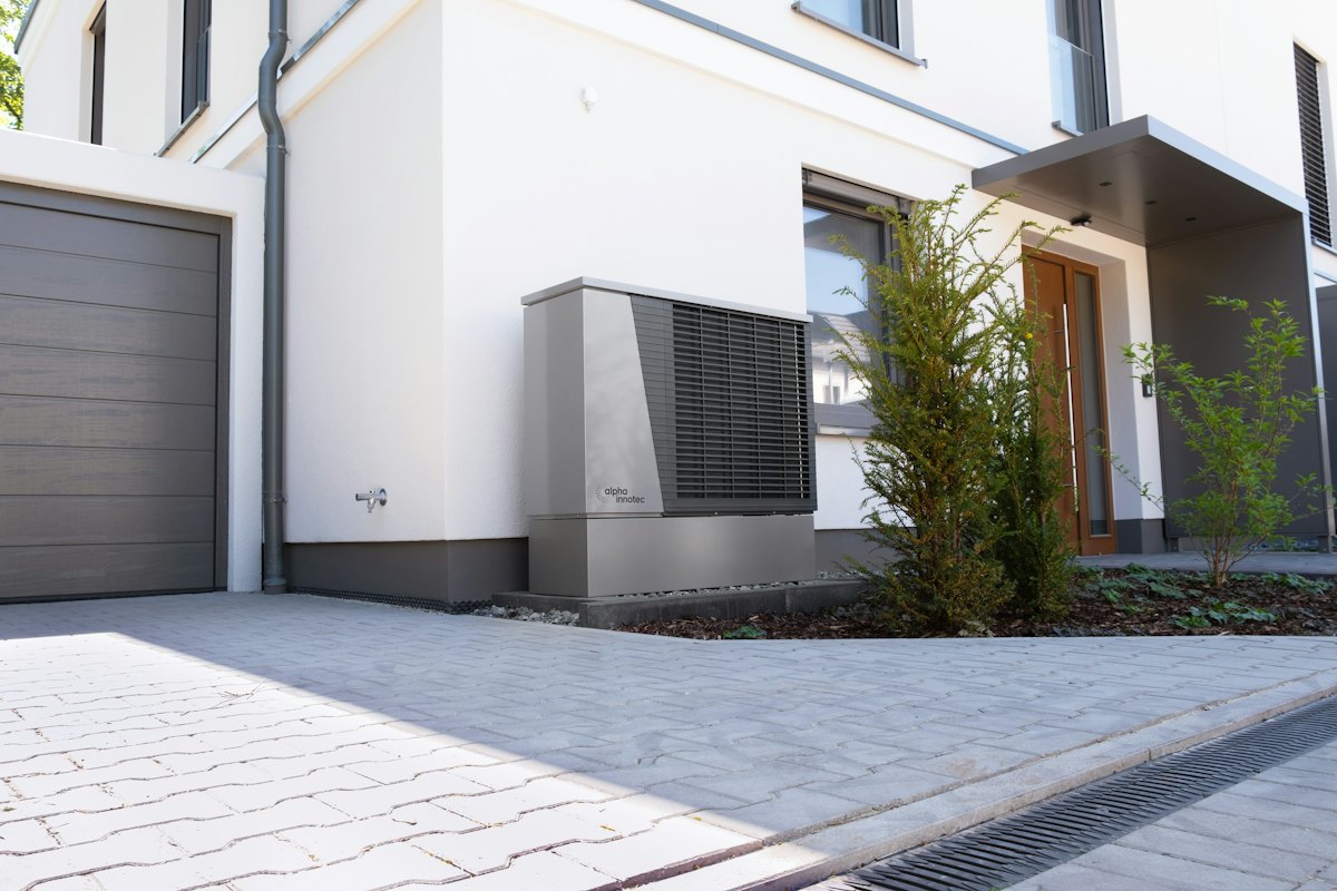 A heat pump unit beside a modern house